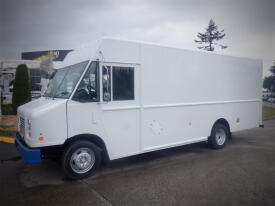 A 2011 Ford E-450 box truck with a plain white exterior and large cargo space on the side