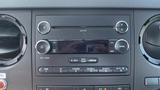 Dashboard of a 2011 Ford F-450 SD featuring a radio player with buttons for volume control and media selection