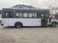 A 2017 Chevrolet Express bus with a white exterior and large windows, featuring side doors and a step ladder for entry