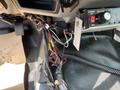 A 2010 Ford F-550 dashboard showing exposed wiring and control panel with power switch and speed control adjustments