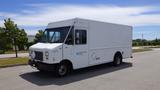 White 2011 Ford Econoline truck with a flat front and boxy shape featuring large windows and a cargo area for transportation purposes