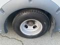 A 2017 Chevrolet Express van's wheel showing the tire tread and rim with visible wear