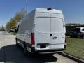 A white 2022 Mercedes-Benz Sprinter van is parked with its rear facing the viewer showcasing its sleek design and branding