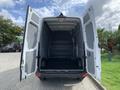 A 2017 Mercedes-Benz Sprinter van with wide-open rear doors revealing a spacious, empty cargo area