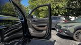 A 2018 Chevrolet Tahoe with an open front door showcasing the interior features and wood trim accents