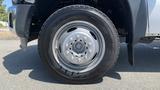 Close-up of a silver wheel with a black tire on a 2011 Ford F-450 SD