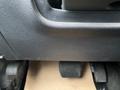 Close-up of the footwell in a 2014 Ford F-150 showing the brake and accelerator pedals