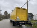 A yellow 2018 International 26 foot cube truck with air brakes parked on the side of a road