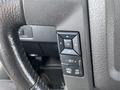 Steering wheel controls of a 2013 Ford F-150 featuring buttons for navigation and settings