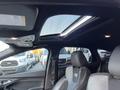 Interior view of a 2018 Ford Focus with a sunroof and sporty seating including an RS badge on the driver's seat