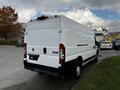 A white 2019 RAM Promaster van viewed from the rear with a simple design and no windows in the back doors