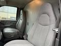 Interior view of a 2009 Chevrolet Express showing gray upholstered driver and passenger seats with a textured design