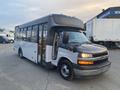 2017 Chevrolet Express bus with a black and white exterior featuring large windows and a spacious interior