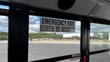 A 2014 Freightliner Thomas Bus Diesel with an emergency exit sign displayed prominently on the interior window