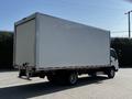 A 2020 Hino 195 truck with a large blank cargo box and a single rear axle viewed from the back quarter angle