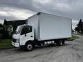 A 2018 Hino 195 box truck with a white exterior and a large cargo area in the back, parked on a street