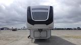 A 2021 Forest River Cedar Creek travel trailer with a sleek front design featuring the name "CEDAR CREEK" prominently displayed across the windshield