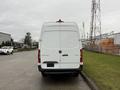 A white 2019 Mercedes-Benz Sprinter van viewed from the rear with a tall boxy shape and the brand logo on the back door