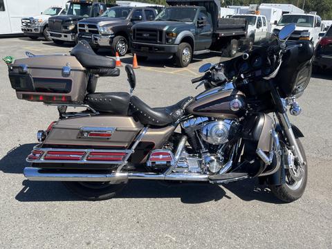 A 2004 Harley-Davidson FLHTCUI motorcycle with a classic design featuring chrome accents saddle bags and a comfortable seat