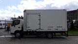 A 2016 Hino 195 box truck with a white exterior and a side door visible in the middle of the cargo area