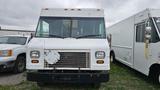 A white 2006 Ford Econoline van with a boxy shape and a front grille featuring horizontal slats and round headlights