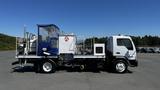 A 2006 Ford LCF 550 truck with a blue tarp and equipment mounted on the bed suitable for work site operations