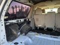 Interior view of a 2013 Ford Expedition showing the rear seating area and an exposed cargo space with removable seating and carpet