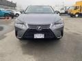 A gray 2021 Lexus NX 300 facing forward with distinctive headlights and a prominent grille