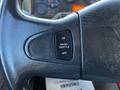 Close-up of the steering wheel of a 2013 International DuraStar 4300 showing a cruise throttle control button labeled ON OFF