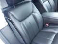 Interior view of a 2008 Cadillac Limousine showing a plush black leather seat with detailed stitching