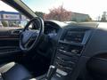Interior view of a 2013 Lincoln MKT showcasing a leather-wrapped steering wheel and a sleek dashboard with a touch screen display and silver accents