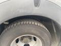 Close-up of the tire and wheel of a 2017 Chevrolet Express showing the tread pattern and metal rim