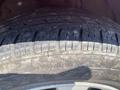 Close-up of a worn tire on a 2007 Toyota Camry Hybrid showing visible tread wear and dirt on the surface