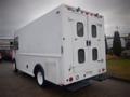 A white 2003 Freightliner MT45 Chassis with rear doors and black bumpers, designed for commercial use