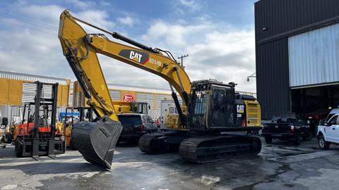 A 2018 Cat 326F Track excavator with a large front bucket and tracks visible in the foreground