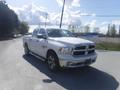 A 2019 RAM 1500 Classic Eco Diesel pickup truck in white with four doors and chrome accents parked on a road