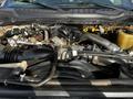 Close-up of the engine compartment of a 2018 Ford F-550 showcasing various components like the turbocharger intake pipes and coolant reservoir