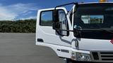 A white 2006 Ford LCF 550 truck with an open driver's side door showcasing the interior and side mirror