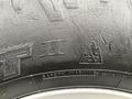 Close-up of a tire from a 2017 Ford F-150 showing the tread pattern and safety warning markings