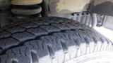 Close-up of the tire tread on a 2011 Ford Econoline showing detailed traction patterns and wear indicators