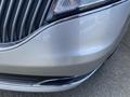 Close-up of the front grille and bumper of a silver 2013 Lincoln MKT showcasing its sleek design and chrome accents