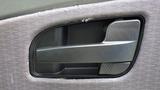 Close-up of a black door handle on the interior of a 2012 International TerraStar vehicle