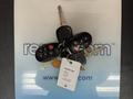 A set of car keys for a 2013 Toyota Sienna featuring multiple buttons and a key tag with vehicle information