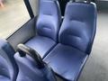 A pair of blue fabric seats from a 2018 Chevrolet Express with a textured surface and a black armrest