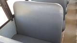 Interior view of a gray vinyl bus seat in a 2014 International 3000 with a focus on the backrest and seat design