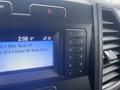 Dashboard of a 2021 Ford F-550 featuring a digital display and numbered buttons for radio controls