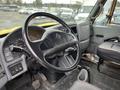 Interior view of a 2007 International 4300 featuring a black steering wheel dashboard gauges gear shift and driver seat