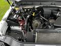 Engine compartment of a 2011 Ford F-250 SD featuring the engine, battery, wiring, and various components