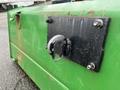 A metal hitch plate with a rounded latch attached to a green implement typical of a John Deere 790 model