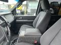 A black 2017 Ford Expedition interior showing the driver's seat and center console with a textured surface